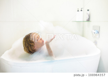 Child playing with foam in bath Child playing with foam in bath 108964357
