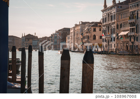 Scenic view of the Grand Canal in Venice, Italy. Serene and tranquil atmosphere with boats visible on the water. Unknown angle and location. No other boats or gondolas in sight. Scenic view of the Grand Canal in Venice, Italy. Serene and tranquil atmosphere with boats visible on the water. Unknown angle and location. No other boats or gondolas in sight. 108967008