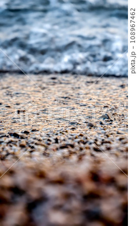 Calm sea waves rolling and braking on rocky ocean beach at sunset. Holiday, summer vacation and tourism 108967462