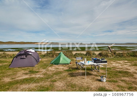 Tents for camping on the shore of a sea bay Tents for camping on the shore of a sea bay 108967756