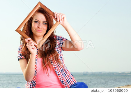 Woman holding frame, travel concept Woman holding frame, travel concept 108968090