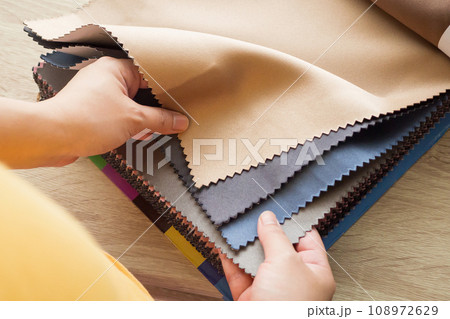 female designer with fabric color samples choosing textile for curtains female designer with fabric color samples choosing textile for curtains 108972629