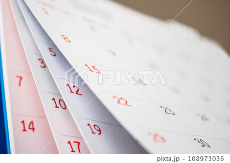 Calendar page flipping sheet close up on office table background business schedule planning appointment meeting concept Calendar page flipping sheet close up on office table background business schedule planning appointment meeting concept 108973036