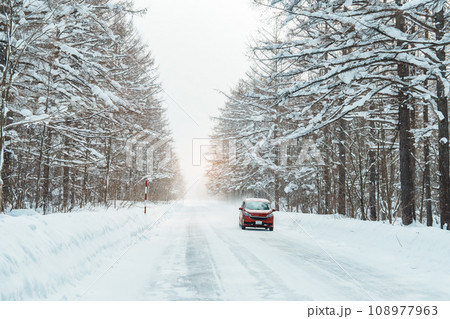 Beautiful snow road forest view during car driving in winter season. Winter travel, Road trip, Adventure, Exploring and Vacation concepts Beautiful snow road forest view during car driving in winter season. Winter travel, Road trip, Adventure, Exploring and Vacation concepts 108977963