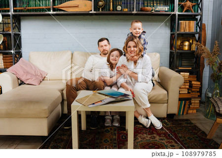 Happy family with two children in their home.  108979785