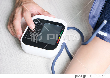 Man check blood pressure monitor and heart rate monitor with digital pressure gauge. Health care and Medical concept 108980376
