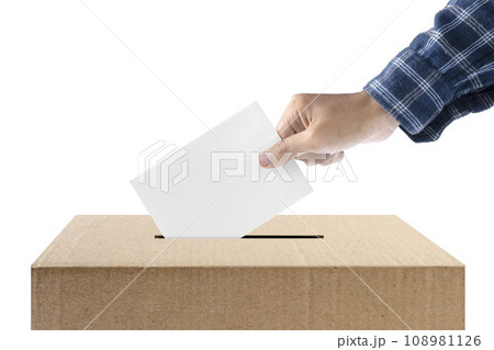 Human hand inserts vote paper into ballot box 108981126
