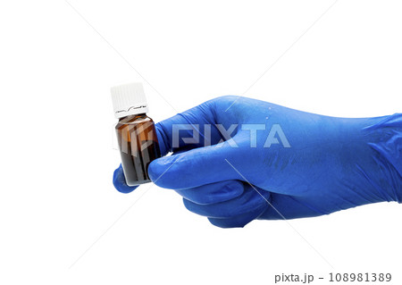 Hand with medical glove holding pill bottle Hand with medical glove holding pill bottle 108981389