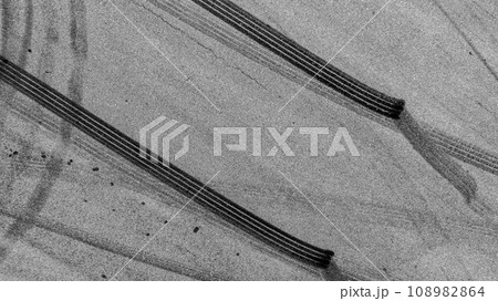 Aerial top view auto tire tread element, Car tire pattern, Wheel tyre tread track, Black tyre print on asphalt road. 108982864