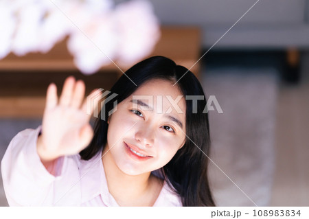 桜の花に手を伸ばす若い女性 桜の花に手を伸ばす若い女性 108983834