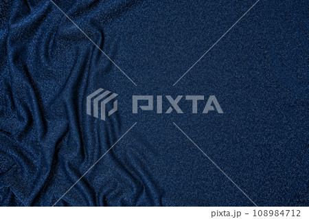 Background of draped dark blue fabric with silver lurex thread 108984712