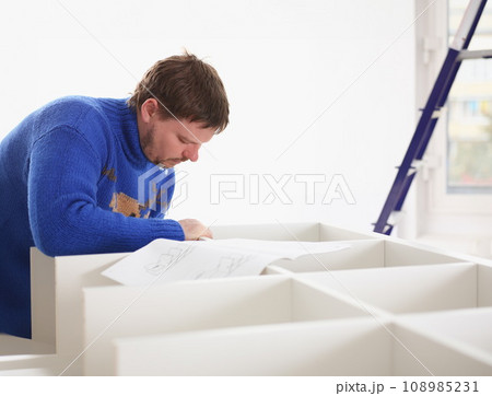 Male arms assembling furniture closeup 108985231