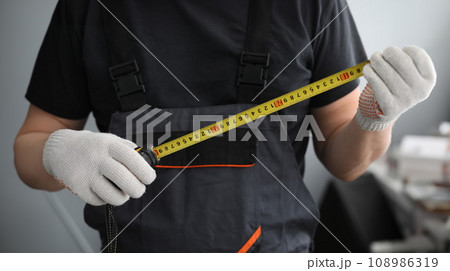 Man holding measuring device Man holding measuring device 108986319