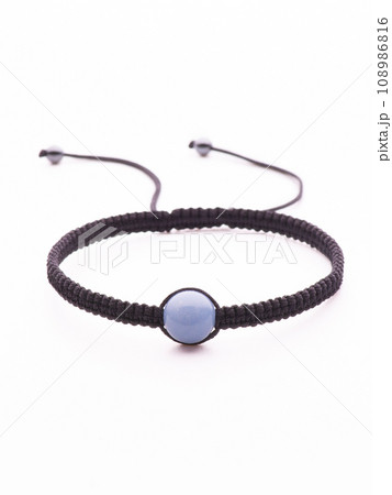 Collection of crystal gemstones bracelets on the table. 108986816