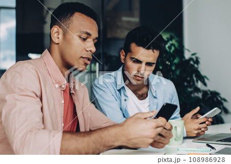 multiracial coworkers discussing information from company website 108986928