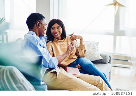 positive dark skinned woman looking at his boyfriend enjoying recreation positive dark skinned woman looking at his boyfriend enjoying recreation 108987151