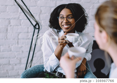 Pretty african american hipster girl laughing with colleague 108987766