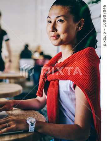 Skilled chinese student dressed in casual wear looking away Skilled chinese student dressed in casual wear looking away 108987846