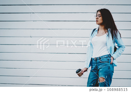 Attractive hipster girl holding tasty coffee to go in hand 108988515