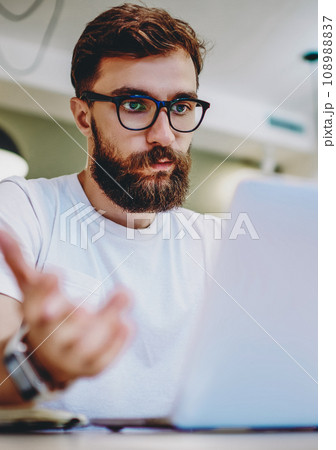 caucasian hipster guy gesturing don't know what to do with bad wireless connection on netbook 108988837