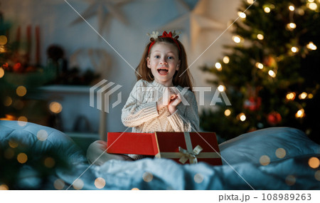girl with Christmas gift 108989263