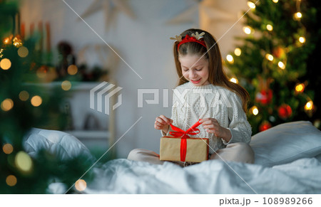 girl with Christmas gift 108989266