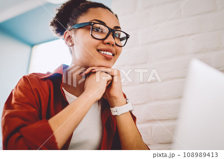 skilled student sitting at table with modern laptop device skilled student sitting at table with modern laptop device 108989413