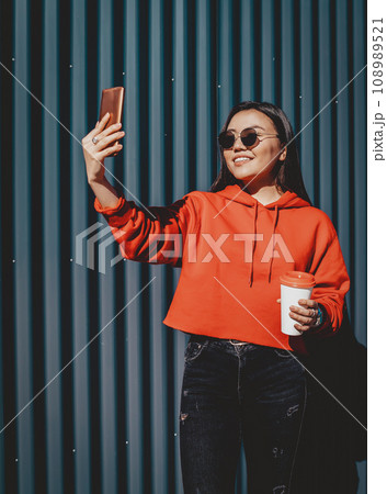 happy smiling hipster girl spending time for creating new images content via cellphone happy smiling hipster girl spending time for creating new images content via cellphone 108989521