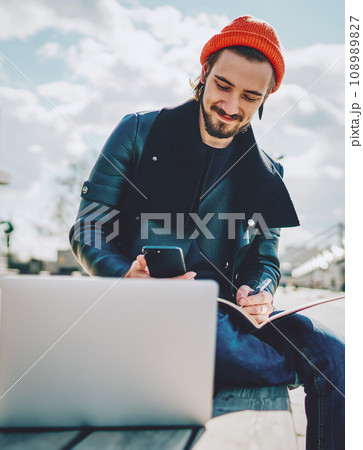 caucasian hipster guy in fashionable outfit chatting with friends 108989827