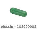A pill of green color isolated on a white background. Macro. 108990008