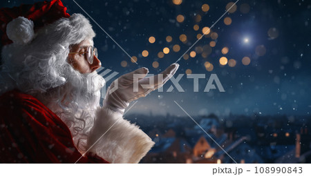 Santa Claus looking at the night city Santa Claus looking at the night city 108990843