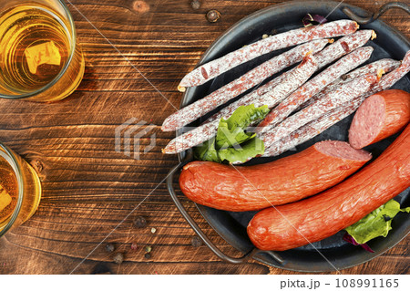 Thin kabanos sausages on wooden background. 108991165