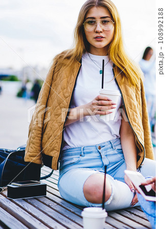 hipster girls resting together with beverage and communicating on summer free time 108992188