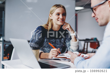 .Two successful students discussing design for website .Two successful students discussing design for website 108992621