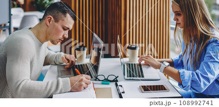 Young man and woman searching information Young man and woman searching information 108992741