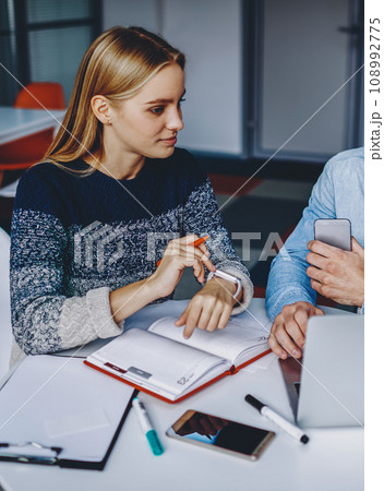 Collaboration of young man and woman preparing common studying project 108992775