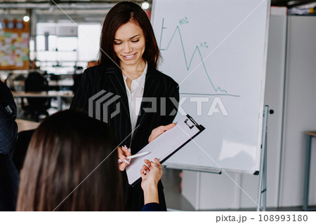 group of business partners in formal wear communicating group of business partners in formal wear communicating 108993180