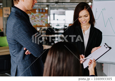 group of business partners in formal wear communicating group of business partners in formal wear communicating 108993305