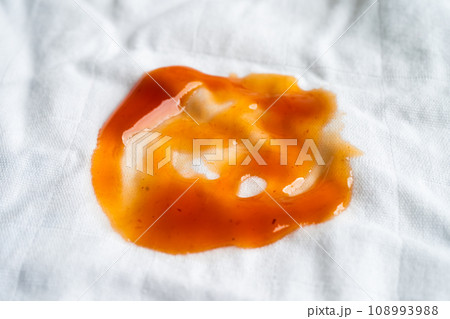 Dirty tomato sauce stain or ketchup on cloth to wash with washing powder, cleaning housework concept. Dirty tomato sauce stain or ketchup on cloth to wash with washing powder, cleaning housework concept. 108993988
