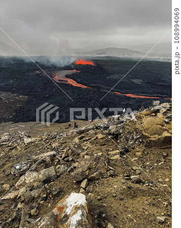 Tourists Watching Volcanic Eruption in Iceland 2023. 108994069