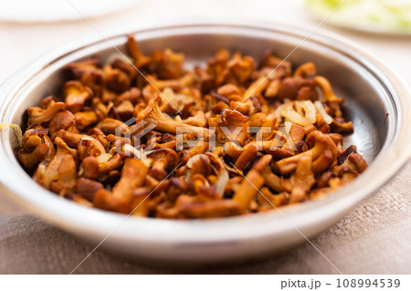 Traditional dishes of Eastern European cuisine. Fried chanterelles in pan 108994539