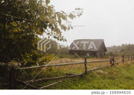 wooden house on a grassy hill in autumn. peaceful relax in the connection with nature. scenic image of picturesque rural nature in countryside in autumn 108994810