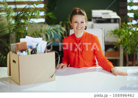 smiling modern woman worker in modern green office 108996462