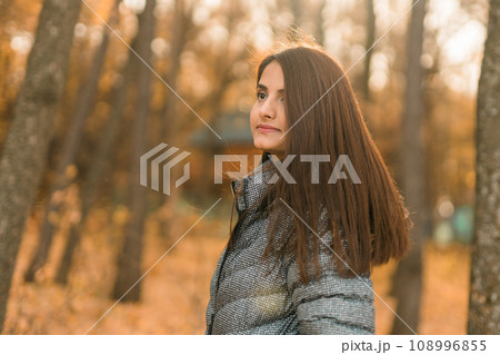 Close up portrait of pretty indian young woman enjoying warm autumn sunny day vacation outdoors copy space mockup. Generation z and gen z concept. Fall Season Close up portrait of pretty indian young woman enjoying warm autumn sunny day vacation outdoors copy space mockup. Generation z and gen z concept. Fall Season 108996855