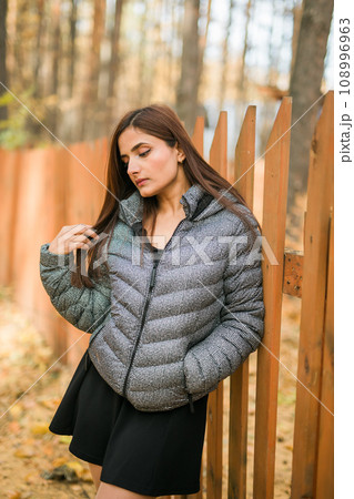 Close up portrait of pretty indian young woman enjoying warm autumn sunny day vacation outdoors. Generation z and gen z concept. Fall Season 108996963