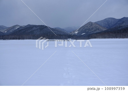 冬の凍結した糠平湖の湖面から見る風景 108997359