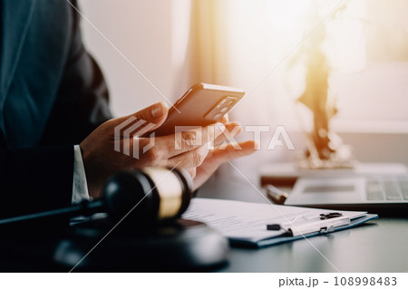Business and lawyers discussing contract papers with brass scale on desk in office. Law, legal services, advice, justice and law concept picture with film grain effect 108998483