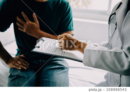 Doctor telling to patient woman the results of her medical tests. Doctor showing medical records to cancer patient in hospital ward. Senior doctor explaint the side effects of the intervention. 108998543