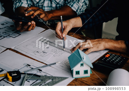 Construction and structure concept of Engineer or architect meeting for project working with partner and engineering tools on model building and blueprint in working site, contract for both companies. 108998553