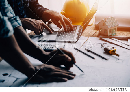 Construction and structure concept of Engineer or architect meeting for project working with partner and engineering tools on model building and blueprint in working site, contract for both companies. 108998558